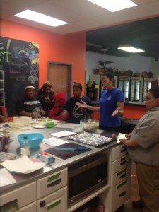 A JLT volunteer teaching at Westside Harvest Market